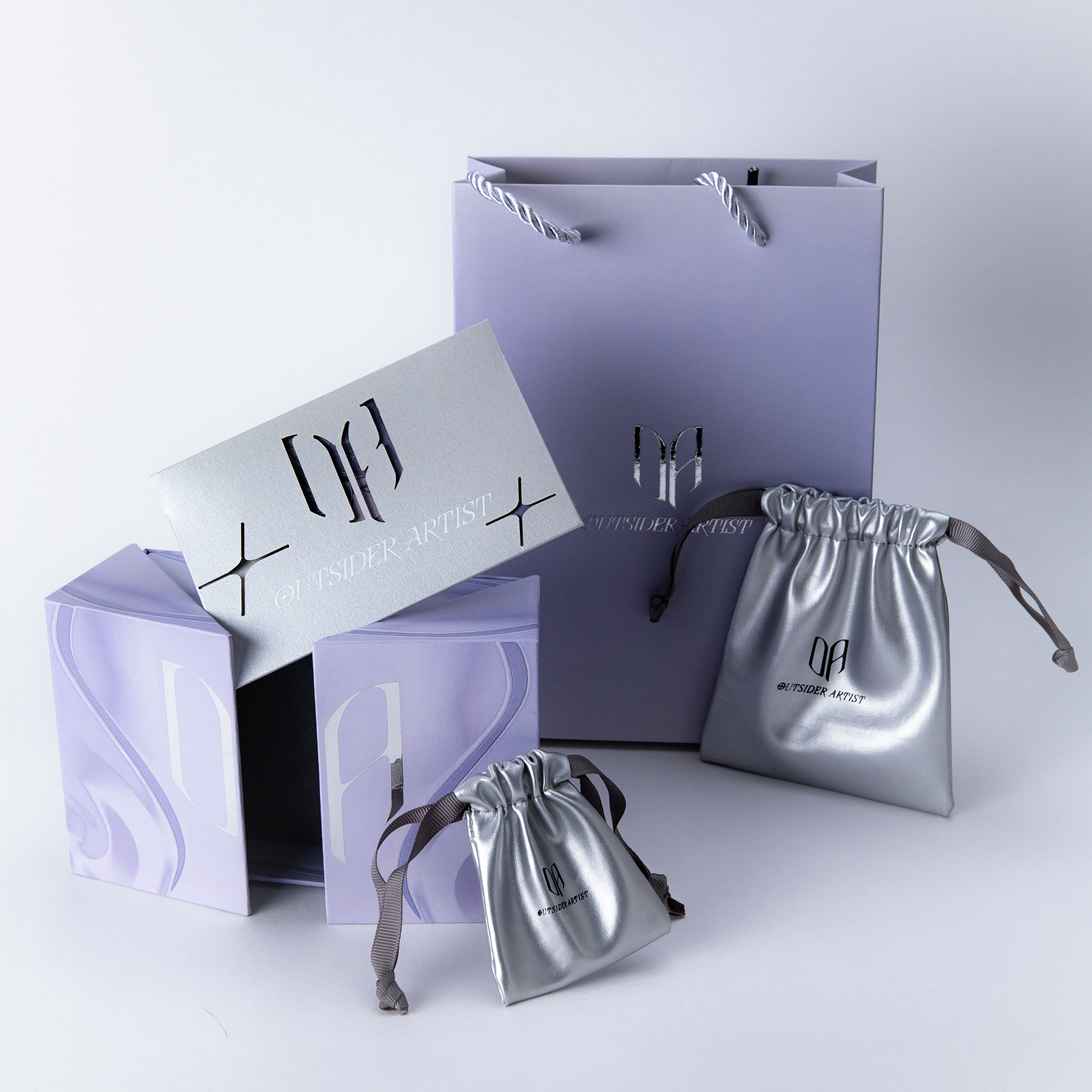 Branded silver and purple packaging set with gift pouch and logo card