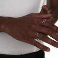 Close-up of hands wearing the Sharp Curve Ring in silver, styled on a male model for a sleek and minimal cyberpunk look.