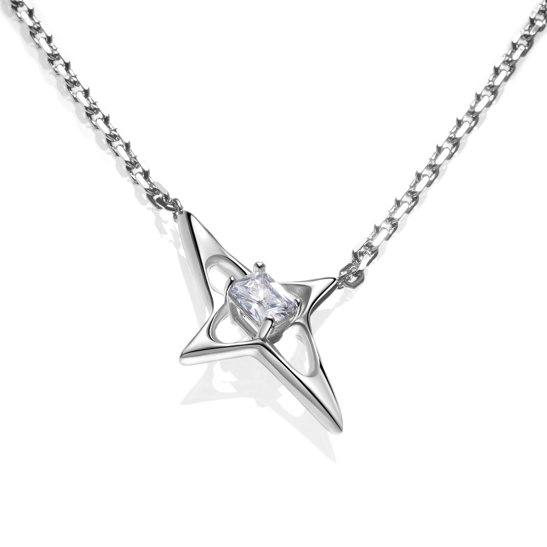 Close-up of a silver geometric star necklace with faceted center stone on a high-shine chain. Sculptural 925 sterling silver pendant with futuristic Y3K design.