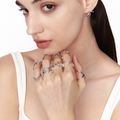 Female model stacking silver Double-Arc Ring on multiple fingers, styled with sculptural silver rings in a modern cyberpunk look
