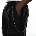 Model styling a 925 silver geometric necklace as a statement pants chain, showcasing its futuristic blade-link design and techwear versatility.