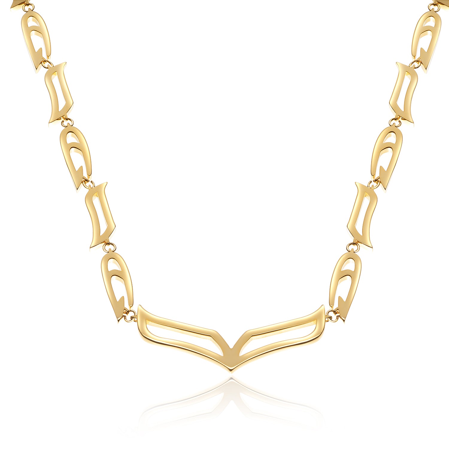 Close-up of the My Heart Soars gold necklace with wing-inspired links and a bold V-shaped centerpiece on white background.