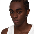 Male model wearing Neural Link silver sculptural earring with futuristic arc shape