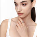 Model wearing a sculptural silver star ring with a central crystal, styled on the index finger for a sleek, futuristic look.