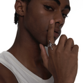 Model wearing a sculptural silver star ring with a crystal centerpiece, styled on the index finger.