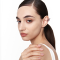 Model wearing aerodynamic 925 silver wing ear cuff with sculptural design, worn without piercing.


